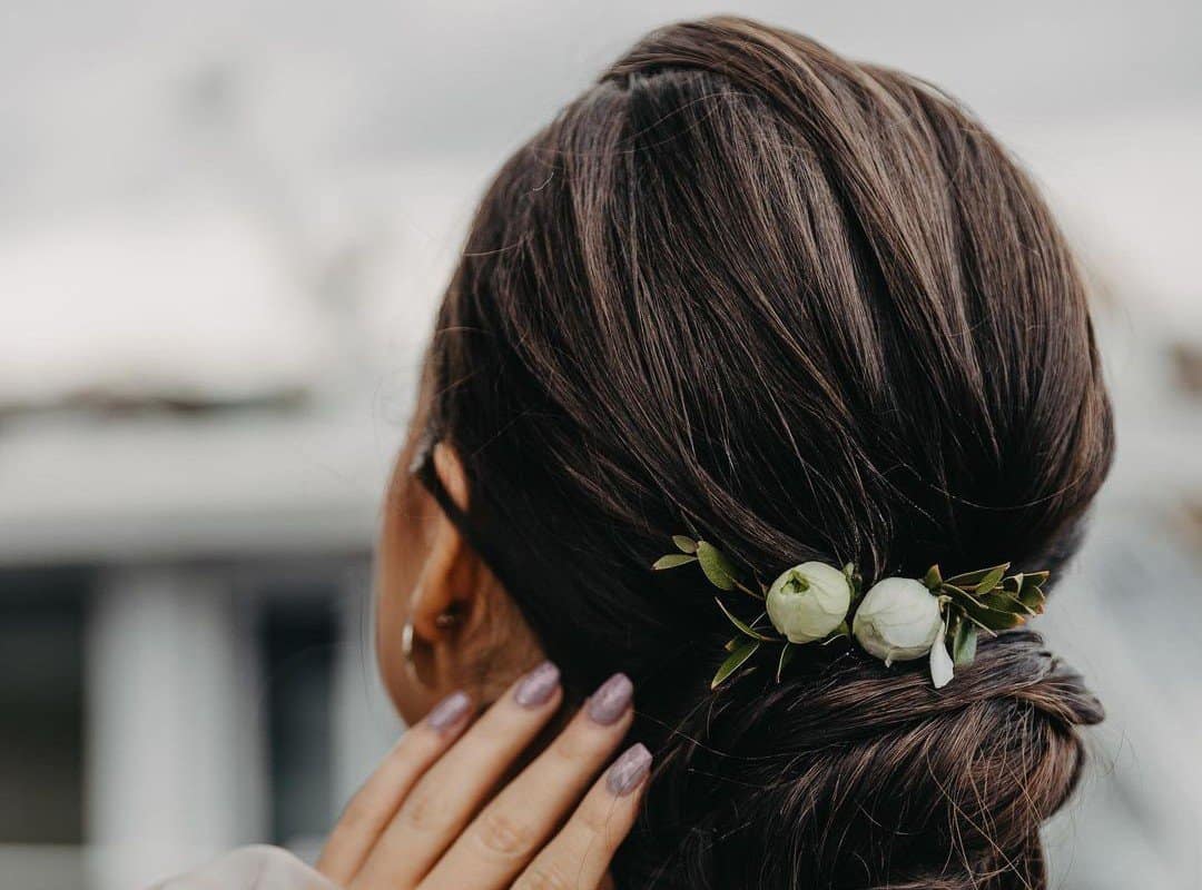 girl with brown updo with flowers