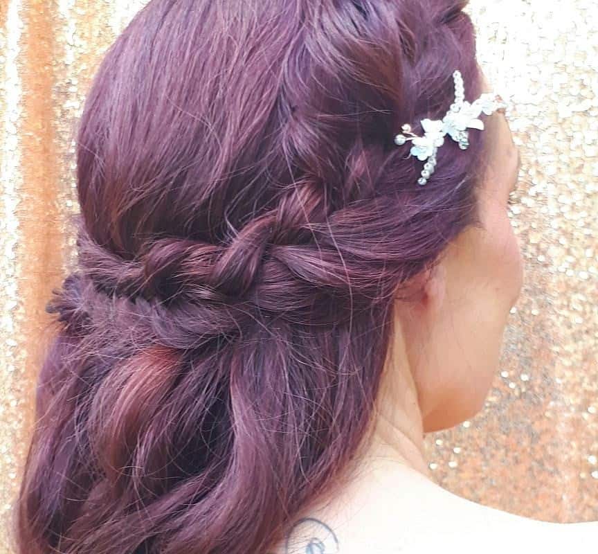 girl with brown and red half updo with flowers
