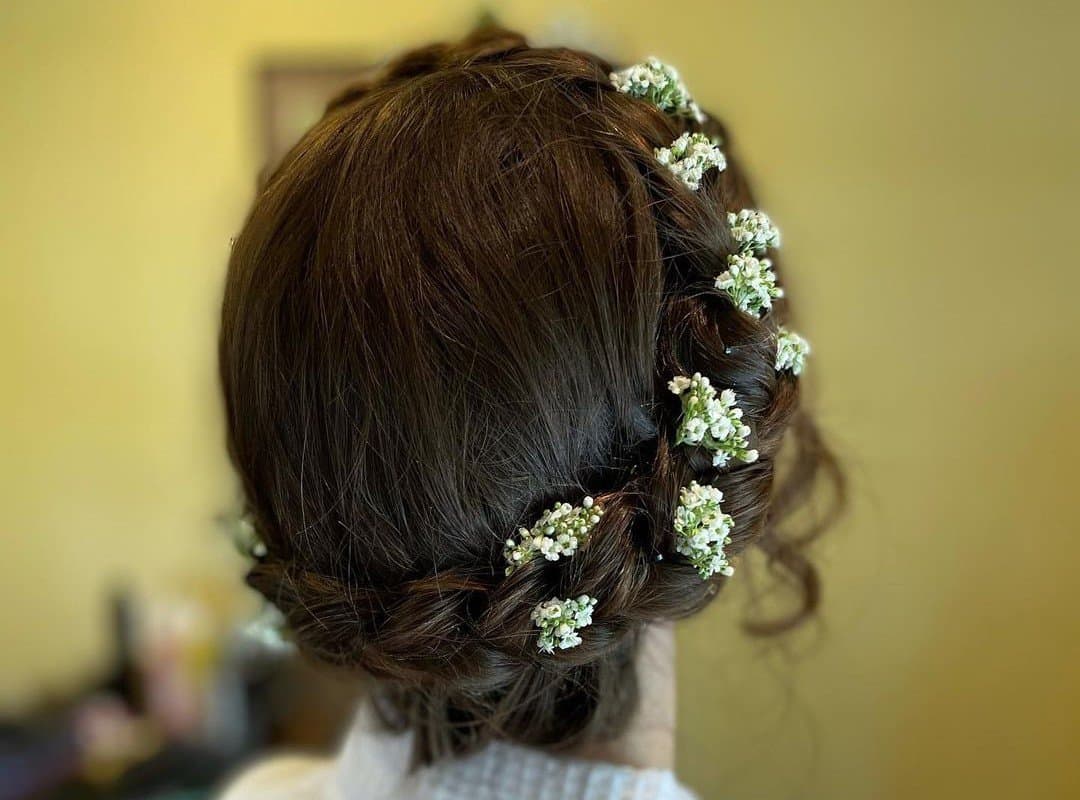 girl with dark brown braided crown with flowers